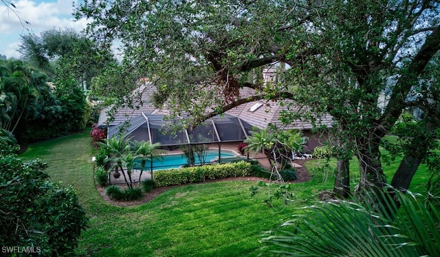 exterior space with a lanai and a yard