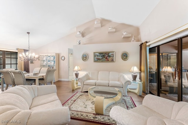 living room with an inviting chandelier, high vaulted ceiling, and light wood-type flooring