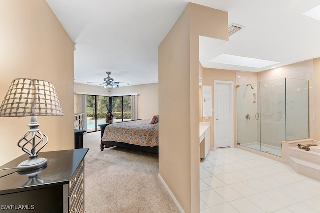 bedroom featuring a skylight and light colored carpet