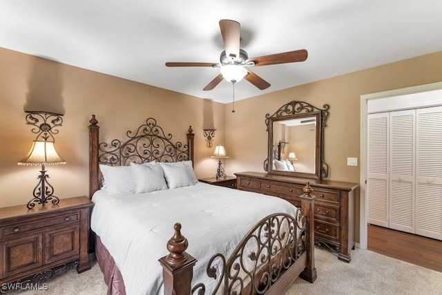 carpeted bedroom featuring ceiling fan and a closet