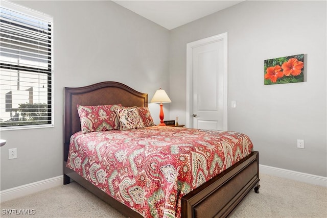 bedroom featuring light carpet