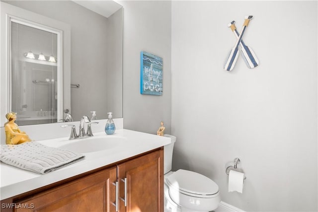 bathroom featuring vanity and toilet