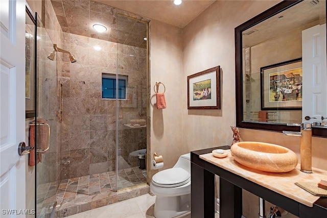 bathroom with an enclosed shower, vanity, and toilet