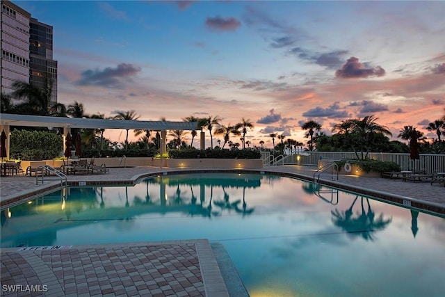 pool at dusk with a patio