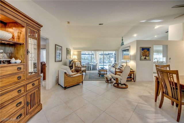 living room with sink, vaulted ceiling, and light tile patterned floors