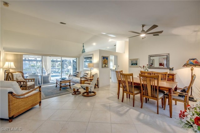 tiled dining area with ceiling fan and high vaulted ceiling