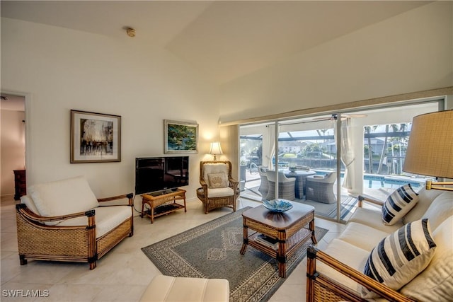 living room featuring light tile patterned flooring, ceiling fan, and a healthy amount of sunlight