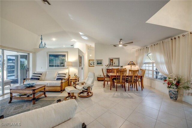 tiled living room featuring ceiling fan and lofted ceiling