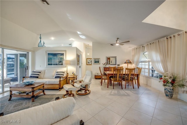 tiled living room with lofted ceiling and ceiling fan