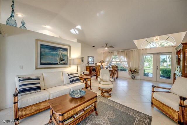 tiled living room featuring vaulted ceiling, french doors, and ceiling fan