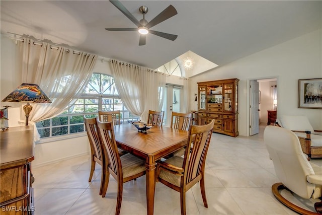 tiled dining room featuring lofted ceiling and ceiling fan