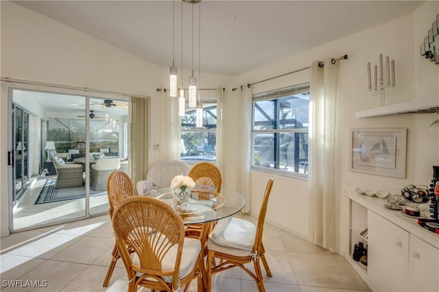 dining room with lofted ceiling and light tile patterned floors