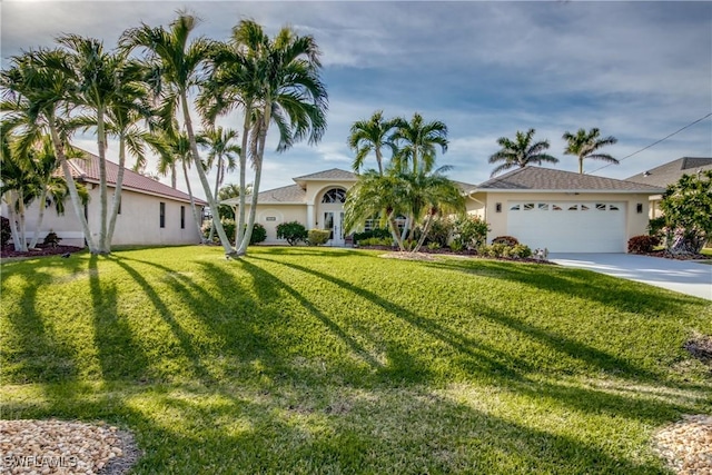 view of front of house with a garage and a front yard