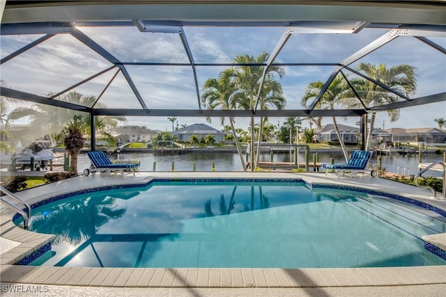 view of pool featuring a water view and glass enclosure