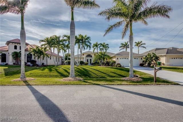 view of front facade featuring a garage and a front lawn