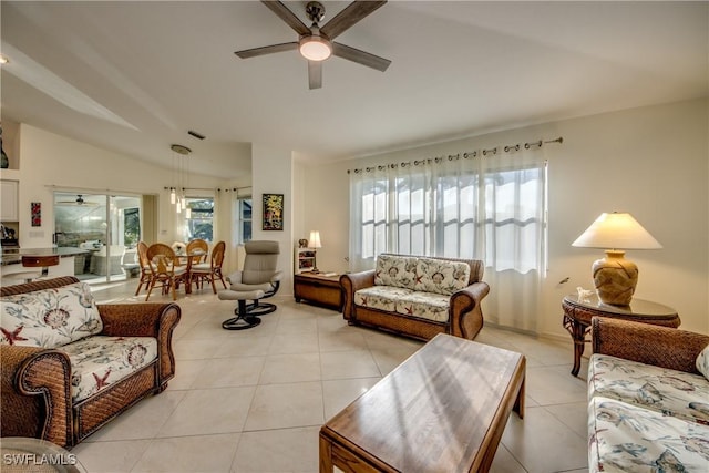 living room featuring vaulted ceiling, light tile patterned floors, and ceiling fan