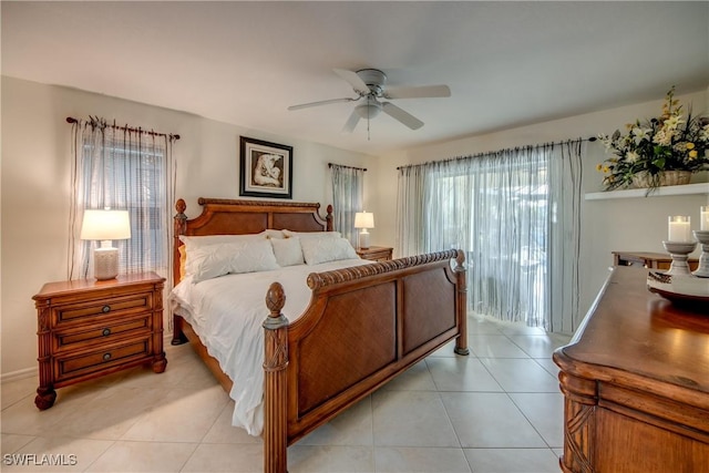 bedroom with ceiling fan, light tile patterned floors, and access to outside