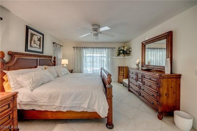 tiled bedroom featuring ceiling fan