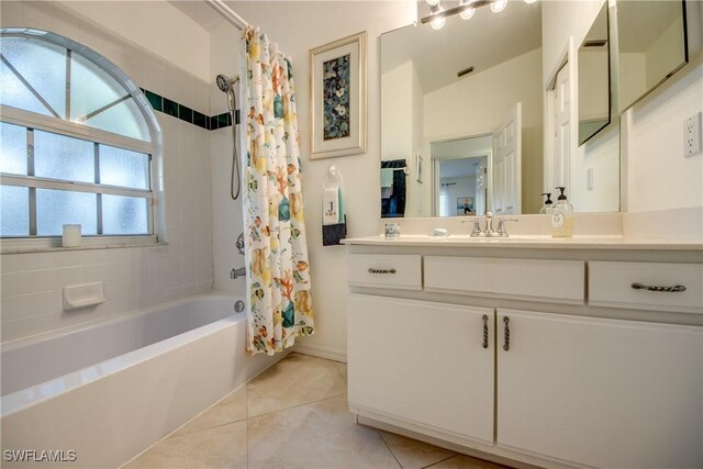 bathroom with shower / tub combo with curtain, tile patterned floors, and vanity