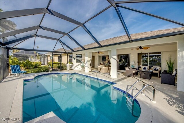 view of swimming pool with ceiling fan, an outdoor living space, a patio area, and glass enclosure