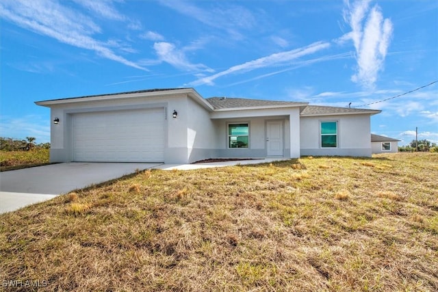 ranch-style house with a garage and a front lawn