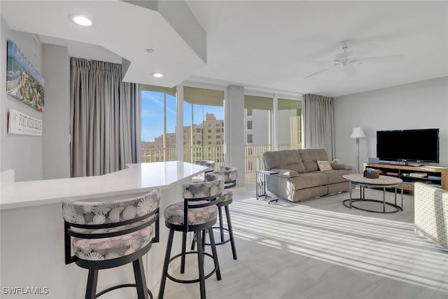 dining area with floor to ceiling windows and ceiling fan