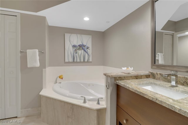 bathroom featuring vanity and a bath