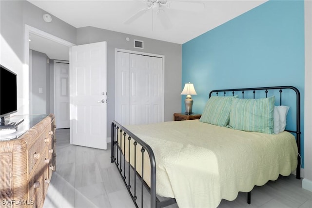 bedroom with ceiling fan and a closet