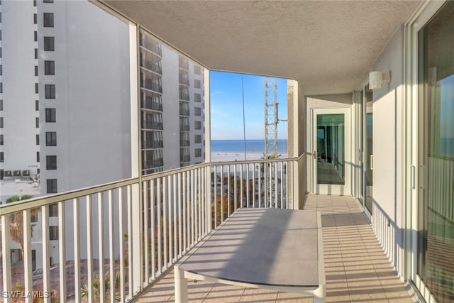 balcony with a beach view and a water view