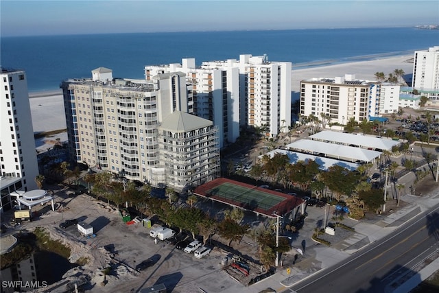 birds eye view of property featuring a water view and a beach view