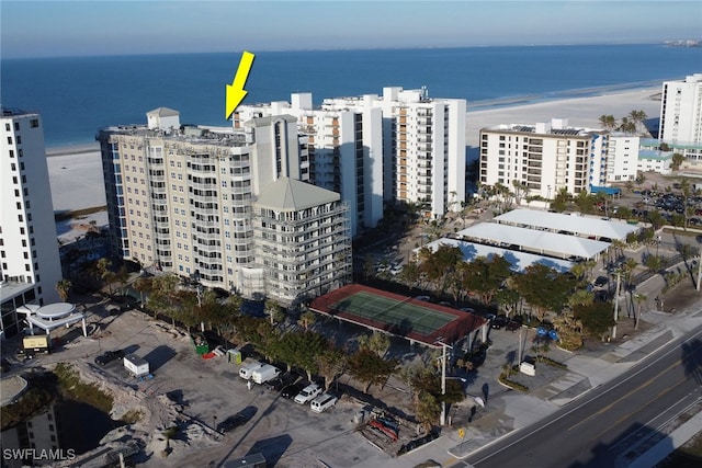 drone / aerial view featuring a water view and a beach view