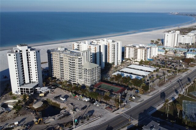 bird's eye view featuring a water view and a beach view