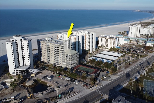 bird's eye view with a water view and a beach view