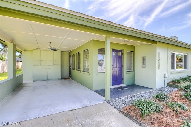 entrance to property featuring ceiling fan