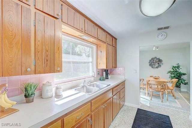 kitchen featuring sink and decorative backsplash