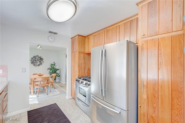 kitchen featuring appliances with stainless steel finishes and light brown cabinets