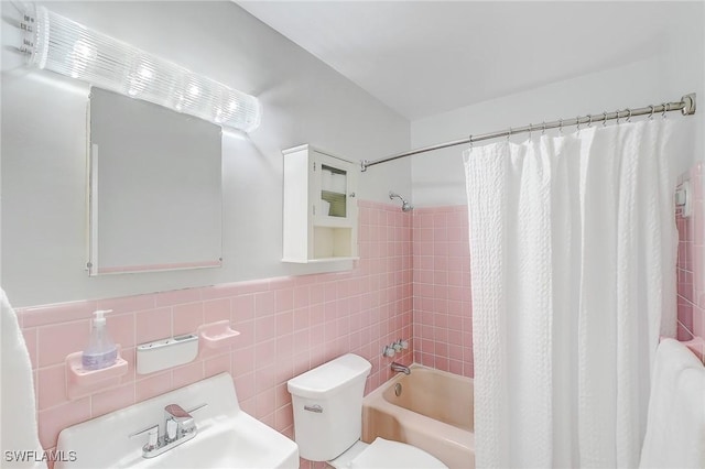 full bathroom with shower / bath combo, sink, tile walls, and toilet