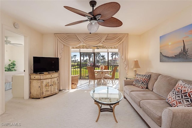 living room with ceiling fan and carpet flooring