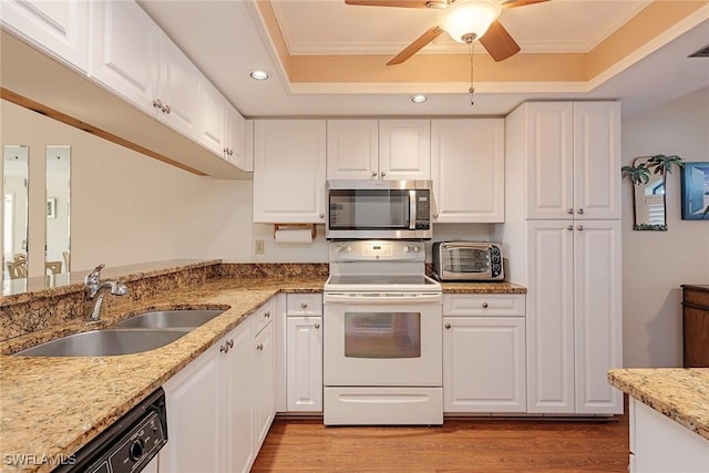 kitchen featuring sink, a tray ceiling, white electric stove, dishwashing machine, and white cabinets