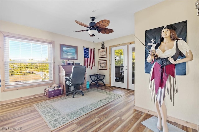 office space with french doors, ceiling fan, and light hardwood / wood-style flooring