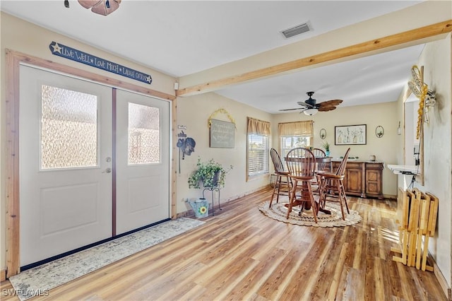 foyer entrance with ceiling fan, beam ceiling, and hardwood / wood-style floors