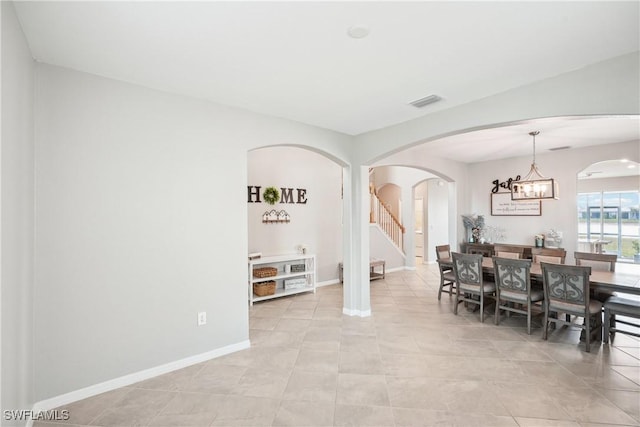 dining room featuring a chandelier and light tile patterned flooring