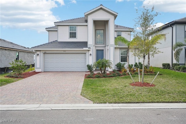 view of property with a garage and a front yard