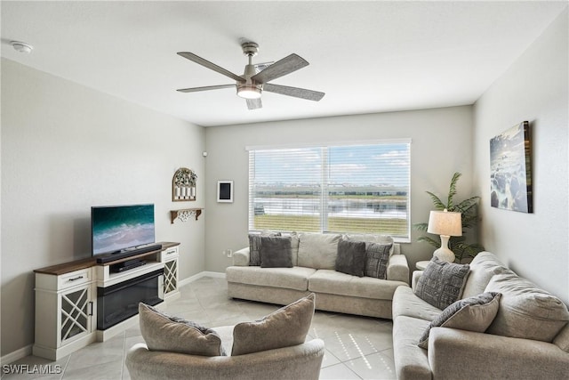 living room featuring light tile patterned floors and ceiling fan