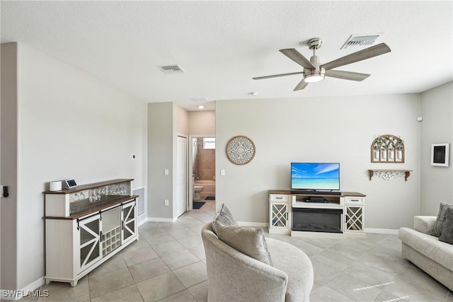 tiled living room featuring ceiling fan