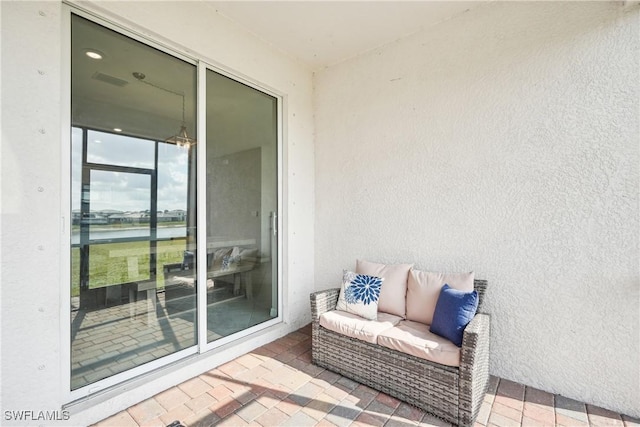 view of patio / terrace featuring a water view and outdoor lounge area