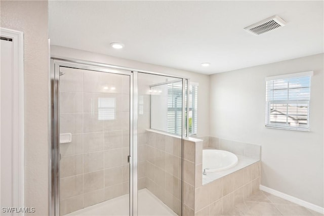 bathroom featuring tile patterned flooring and plus walk in shower