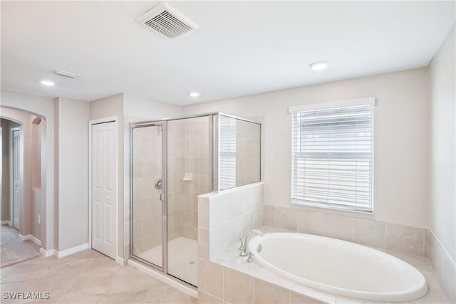 bathroom with independent shower and bath and tile patterned floors