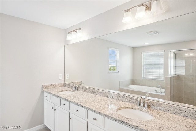 bathroom with vanity and separate shower and tub