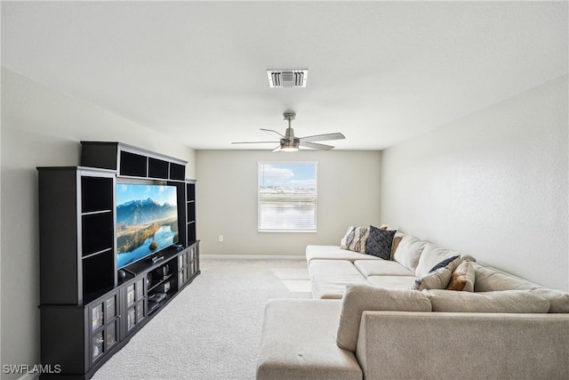 carpeted living room with ceiling fan